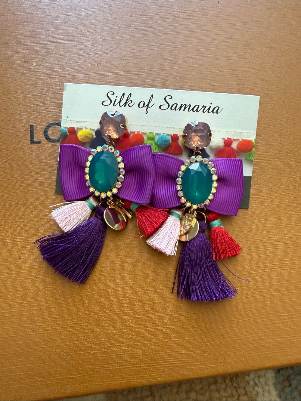 Silk of Samaria Purple Bow Tassel Statement Earrings with Green Gem